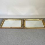 A pair of gilt framed wall mirrors