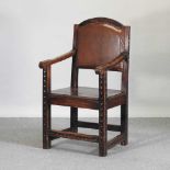 A 19th century continental carved oak open armchair