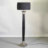 A modern black painted standard lamp and shade