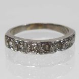 An 18 carat white gold diamond half hoop eternity ring