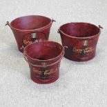 A set of three cola advertising metal buckets
