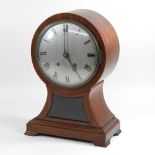 A large Edwardian mahogany cased balloon shaped mantel clock