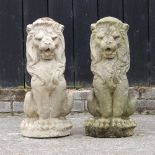 A pair of reconstituted stone models of seated lions