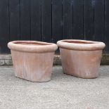 A pair of large terracotta garden planters