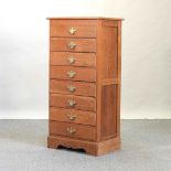 A modern narrow oak chest of drawers
