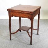 An Edwardian mahogany and inlaid envelope card table