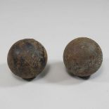 Two antique iron cannonballs