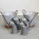 Four various galvanised jugs,