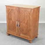 A 1920's light oak cabinet