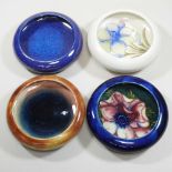 A collection of four Moorcroft pottery pin dishes