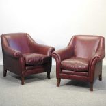 A pair of modern oxblood leather upholstered armchairs