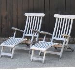 A pair of teak folding garden steamer chairs