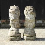 A pair of reconstituted stone garden models of lions