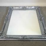 A large silver painted wall mirror