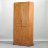 An early 20th century grained pine school cabinet