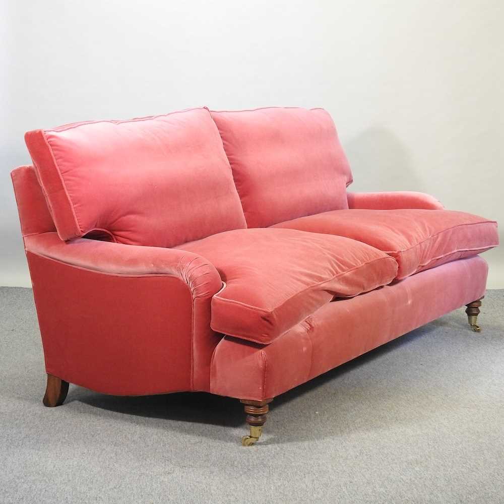 A good quality modern Howard style red velvet upholstered three seat sofa