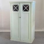 An early 20th century green painted French armoire