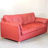 A modern red upholstered sofa bed