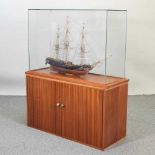 A model ship, HMS Diana, in a glazed case