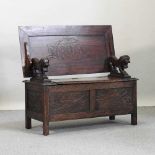 An early 20th century carved oak monk's bench