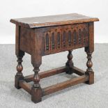 A Victorian carved oak stool