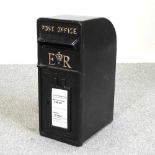 A reproduction black painted metal postbox