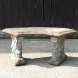 A reconstituted stone curved garden bench