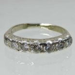 An unmarked diamond half hoop eternity ring