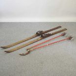 A pair of vintage wooden skis and poles