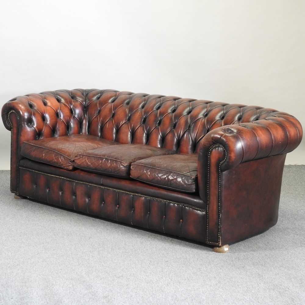 A red leather upholstered button back chesterfield sofa