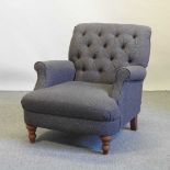 A modern grey upholstered button back armchair