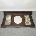 An early 20th century carved oak framed over mantel mirror