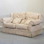 A modern floral upholstered two seater sofa