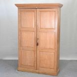 An early 20th century light oak school cupboard