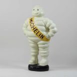 A large painted metal model of the Michelin man