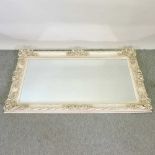 A modern cream painted wall mirror