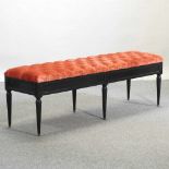 A French style orange button upholstered window seat