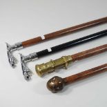 A collection of four reproduction walking sticks