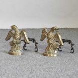 A pair of brass fire dogs