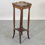 A French gilt metal mounted two tier stand