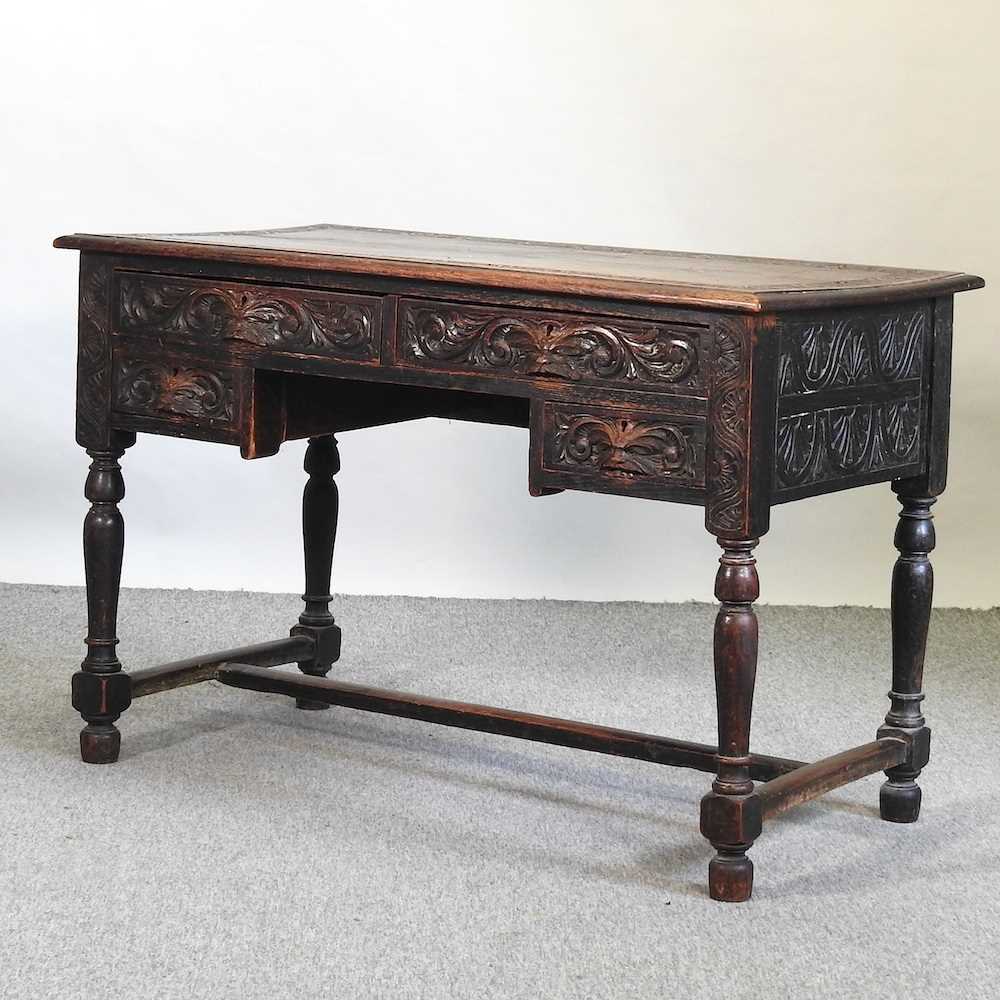 A 19th century carved oak kneehole desk