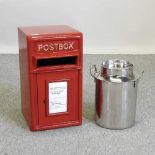 A stainless steel milk churn, together with a red metal postbox
