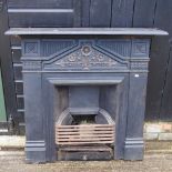 An antique painted cast iron fire insert