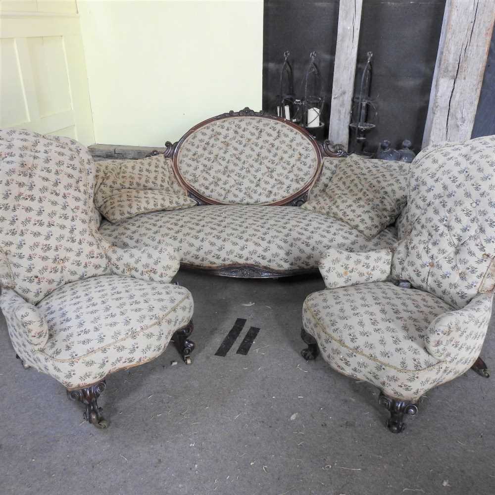 A Victorian mahogany and floral upholstered salon suite