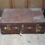 An early 20th century brown leather suitcase