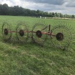 A Vicon tractor mounted hay turner