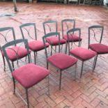 A set of six metal framed dining chairs