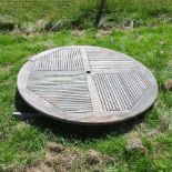 A teak folding circular garden table