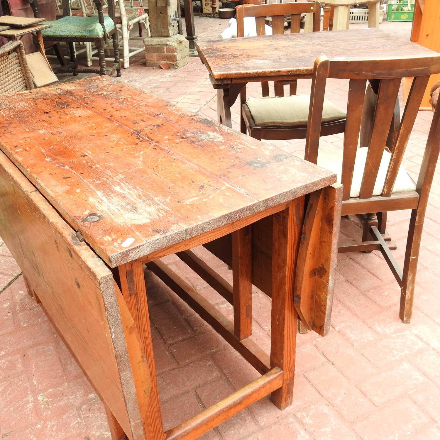 An antique pine drop leaf dining table