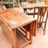 An antique pine drop leaf dining table